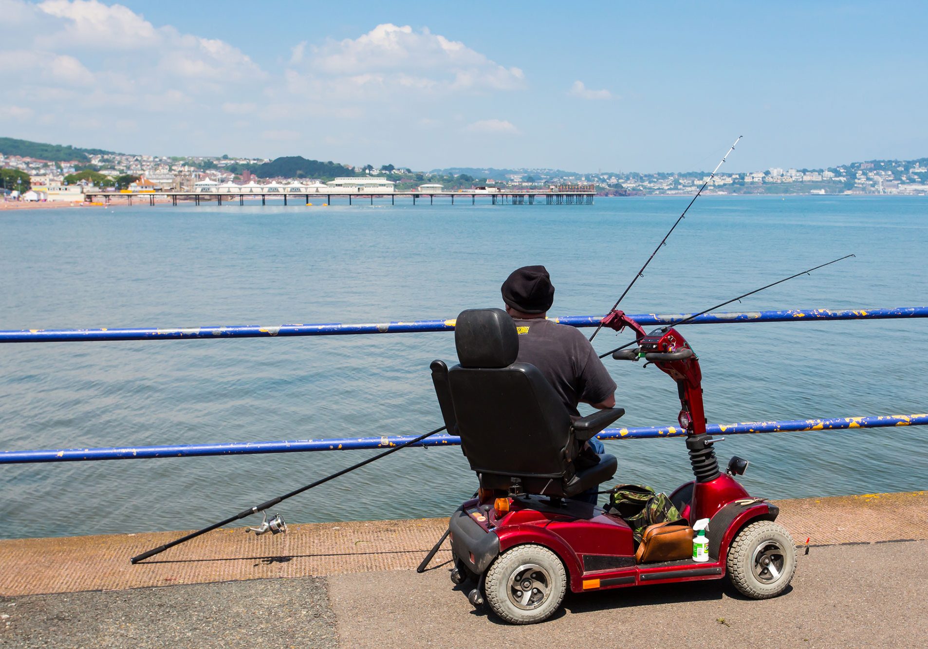 Man fishing on mobility scooter